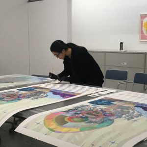 Artist Saya Woolfalk signing her editions in the Printshop, 2019